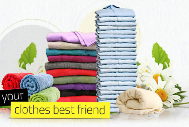 Stack of colorful folded clothes, a stack of blue and white striped clothes, daisies, green leaves, and a yellow label with text.